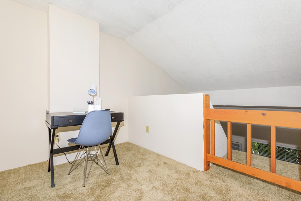 a bedroom with a desk and a chair and a bunk bed