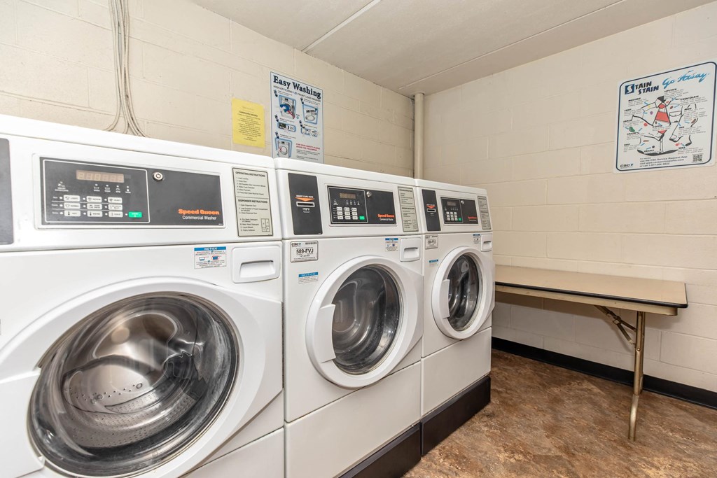 a washer and dryer in a laundry room with two washing machines