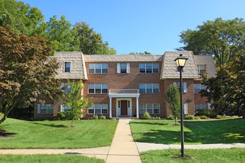a large brick building with a sidewalk in front of it