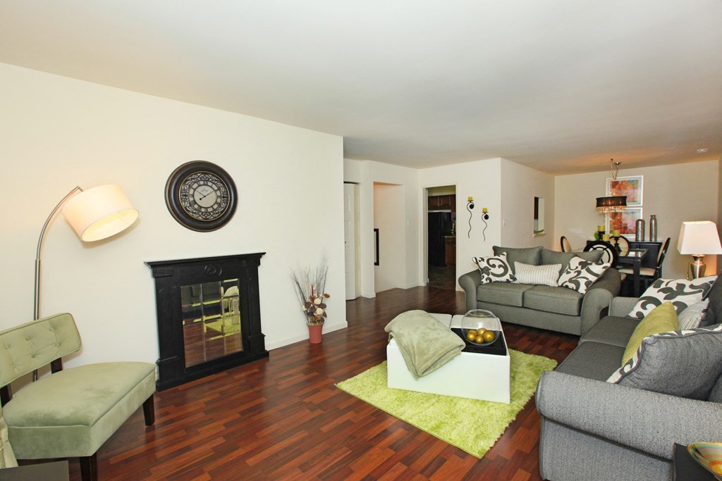 a living room with couches and chairs and a fireplace