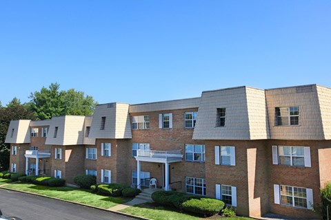 a large brick apartment building with a street in front of it
