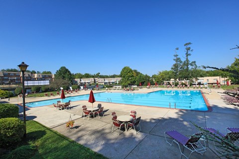 an overhead view of a swimming pool with tables and chairs