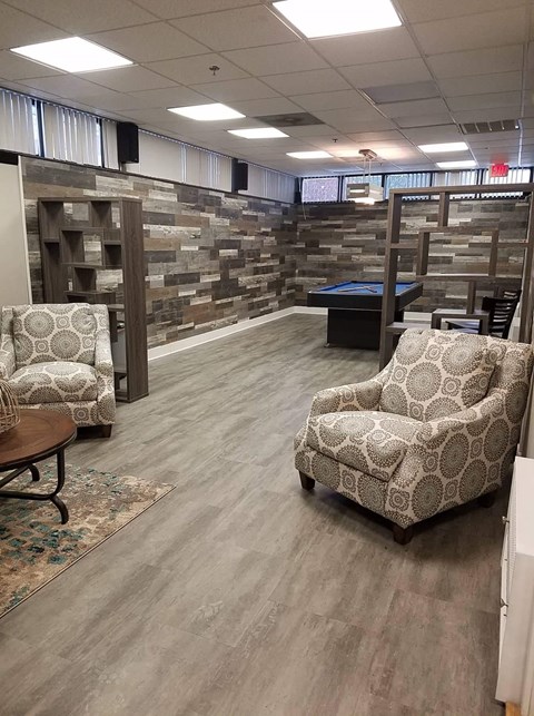 a large room with chairs and a pool table