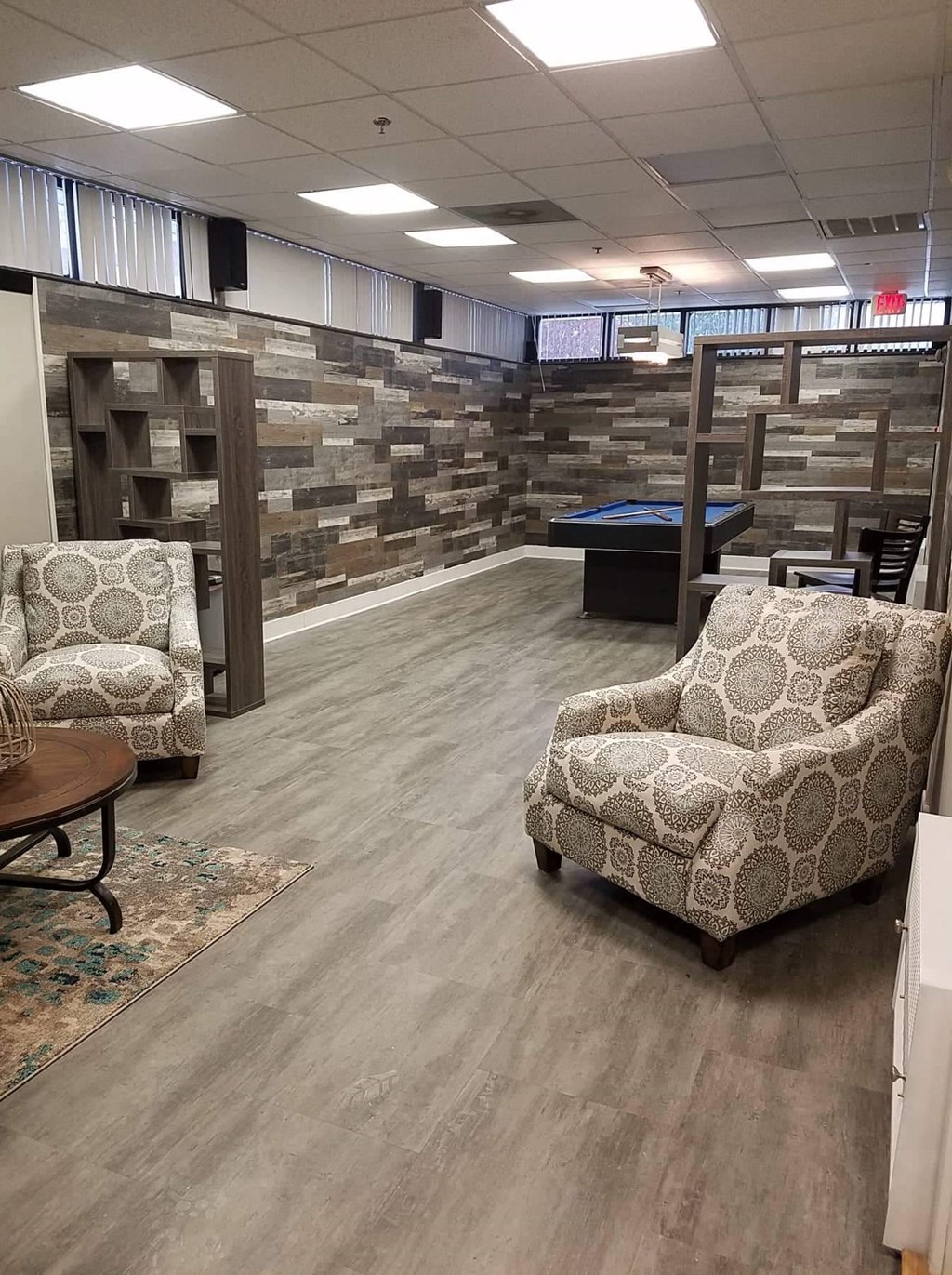 a large room with chairs and a pool table