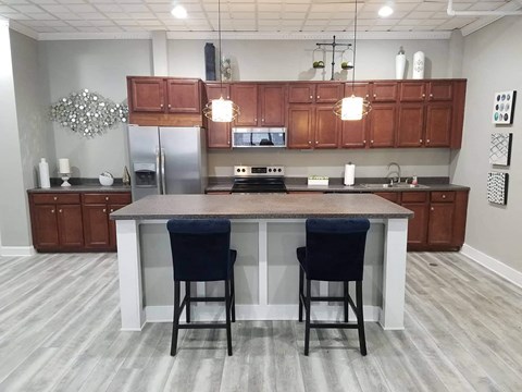 an open kitchen with an island and two chairs