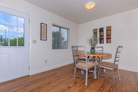a dining room with a table and chairs