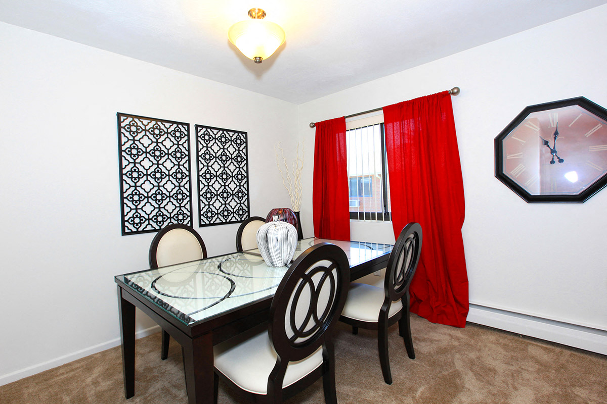 a dining room with a table and chairs