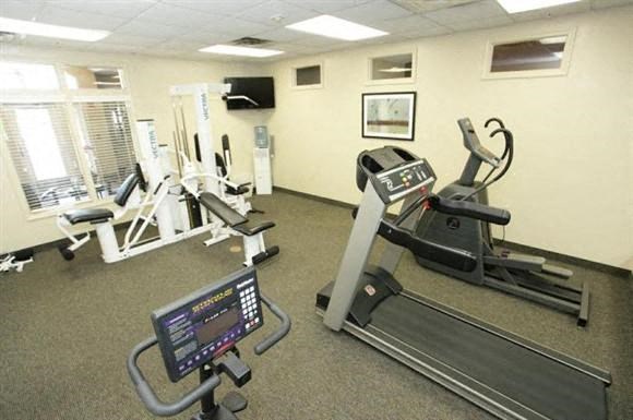 a gym with various exercise equipment in a room