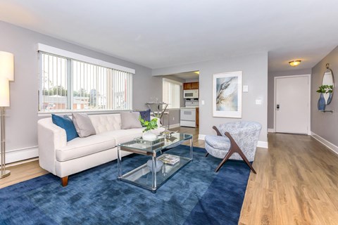 a living room with a white couch and a glass coffee table