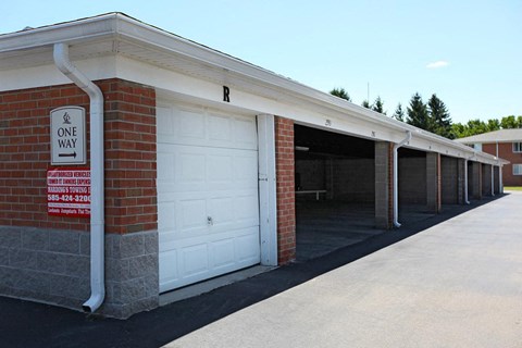 a one way garage door in front of a brick building