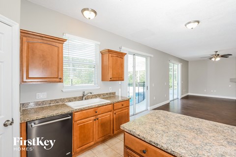 a kitchen with wooden cabinets and granite counter tops
