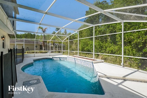 a swimming pool in a pool house with a glassed in pool