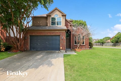 a brick house with a black garage door