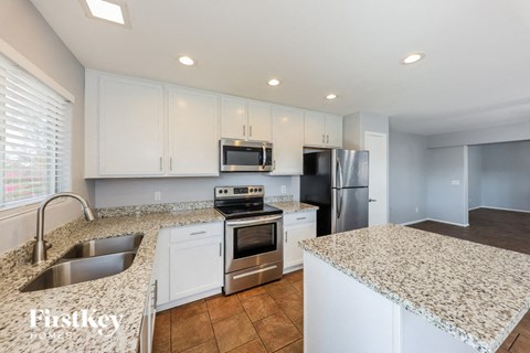 a kitchen with granite counter tops and stainless steel appliances