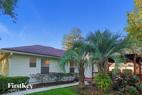 a white house with palm trees in front of it