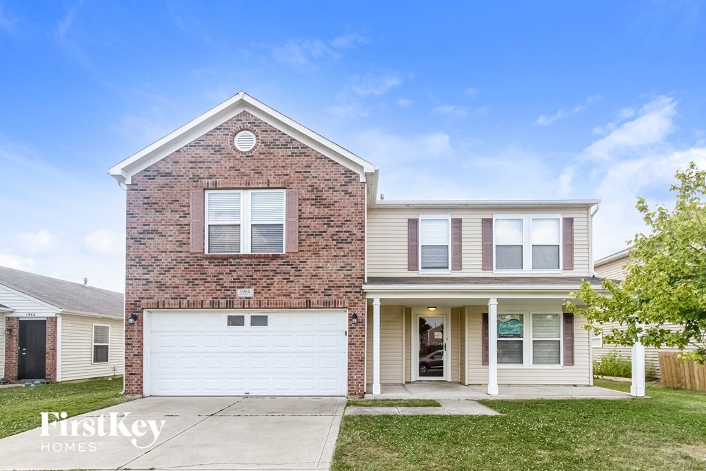 a brick house with a white garage door