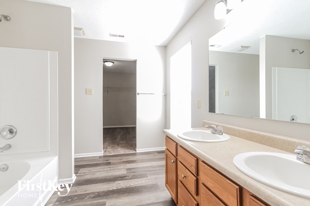 a bathroom with two sinks and a large mirror