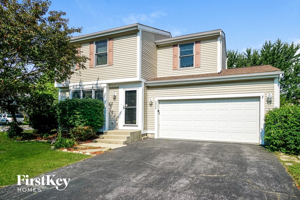 A two-story house with a garage is for sale.