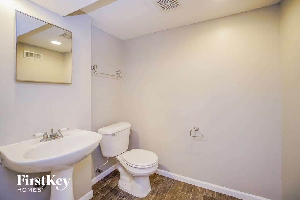A bathroom with a white toilet and sink.