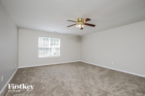 a bedroom with carpet and a ceiling fan