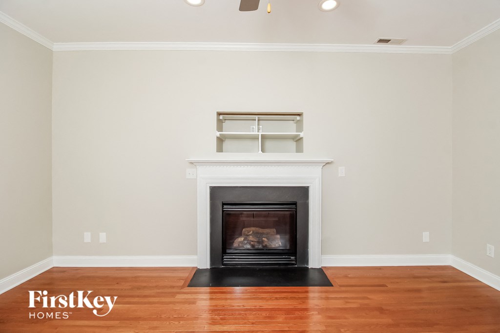 a living room with a fireplace and a wooden floor
