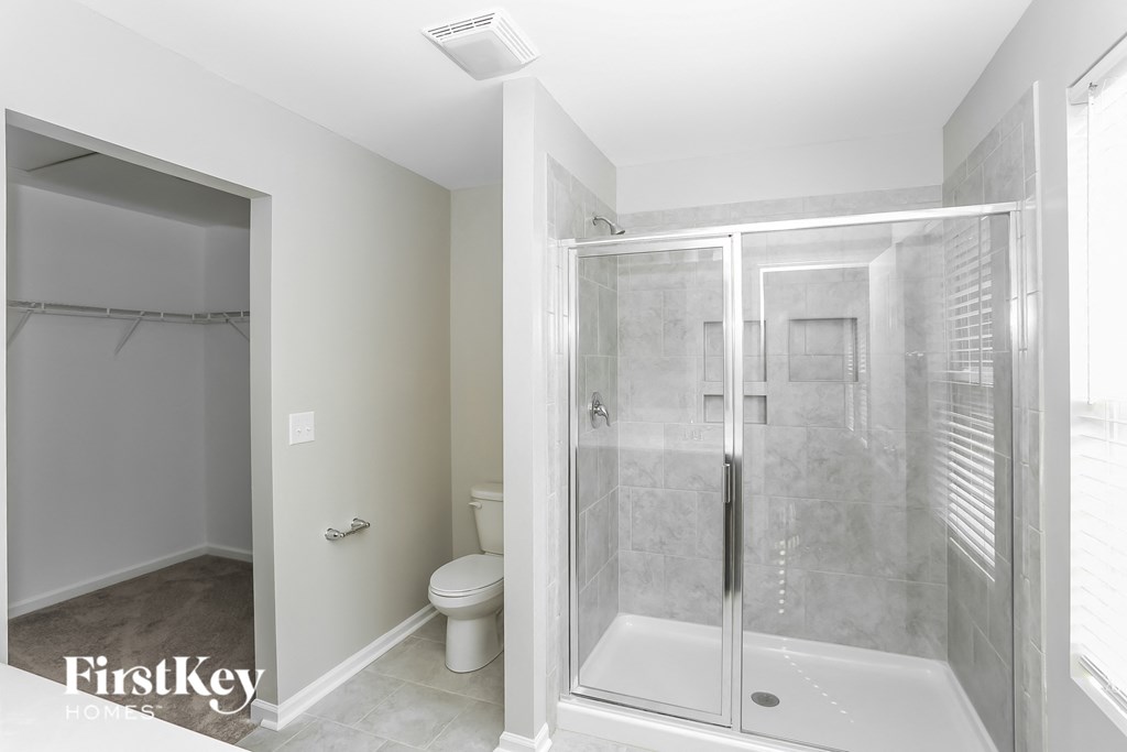 a small bathroom with a shower and a toilet