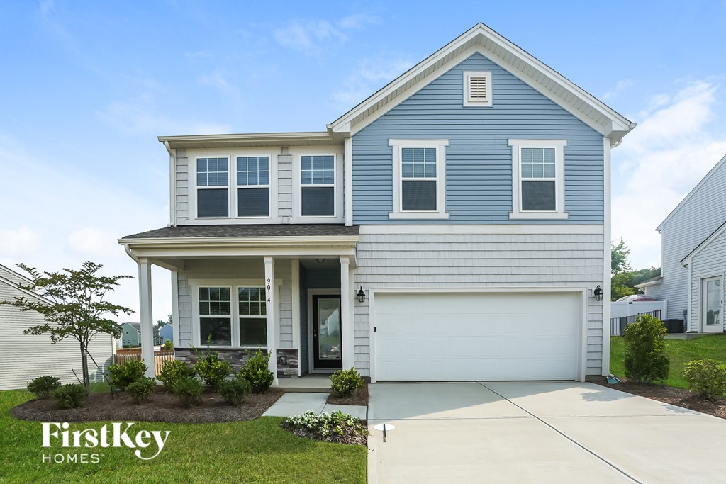 a blue and white house with a sidewalk in front of it