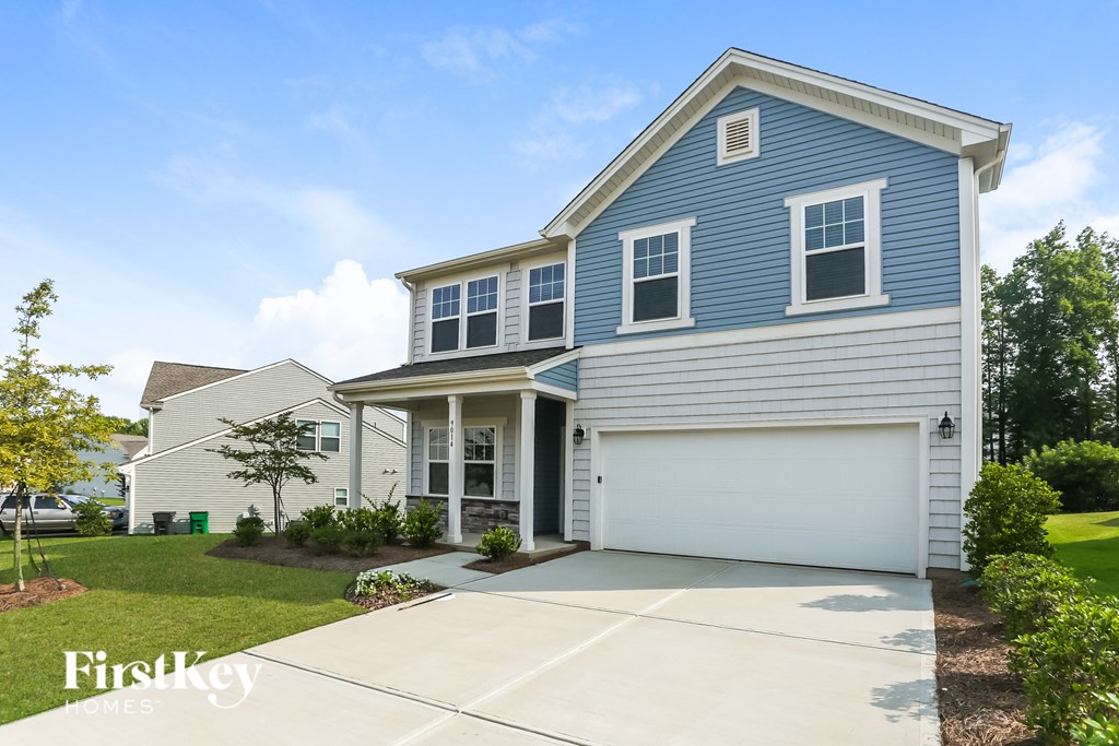 a blue and white house with a white garage door