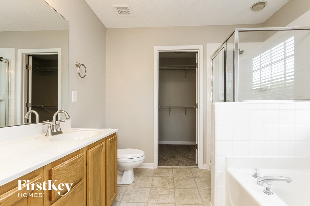 a bathroom with a shower toilet and sink and a bath tub