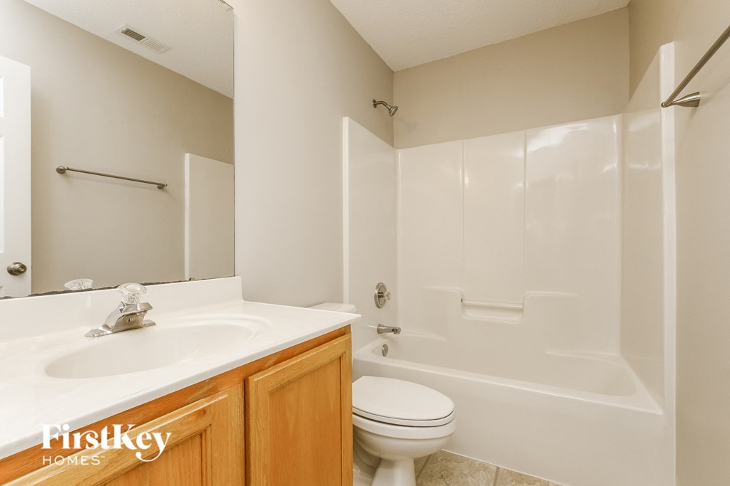 a bathroom with a sink toilet and a shower