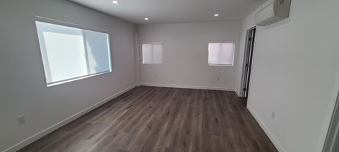 A room with wooden floors and white walls.