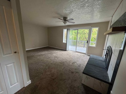 a living room with a couch and a ceiling fan