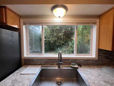 a kitchen with a sink and a window