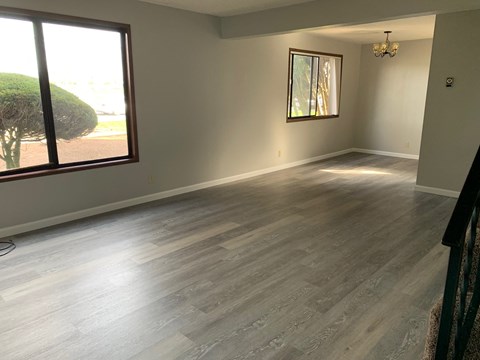 a living room with wood floors and a large window