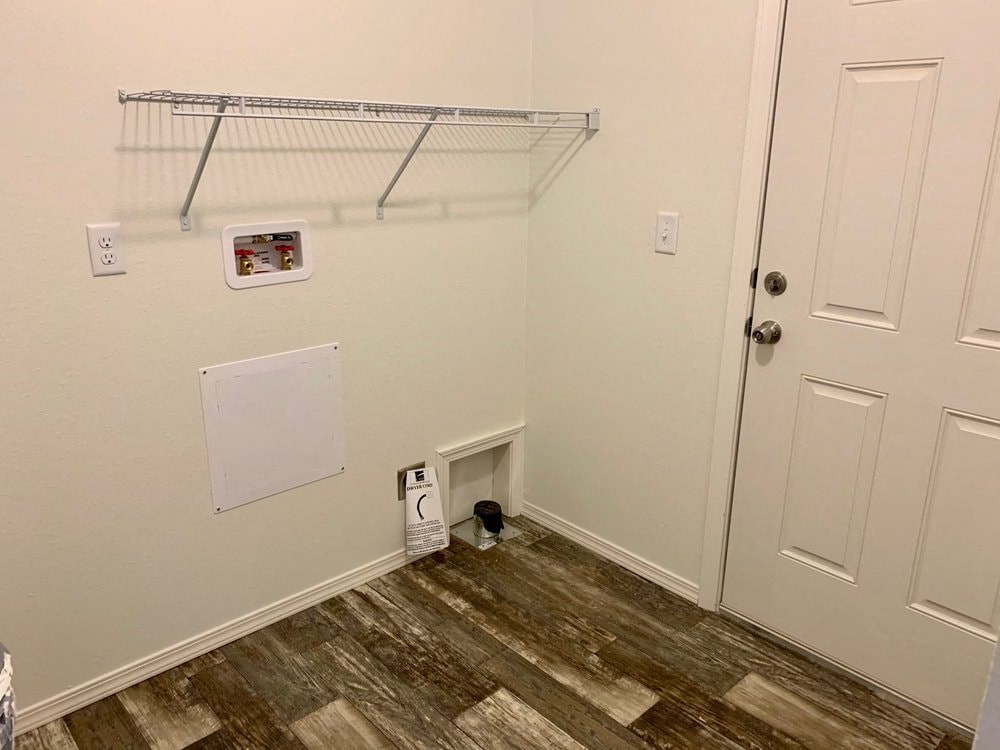 a closet in a bedroom with a door and a shelf on the wall