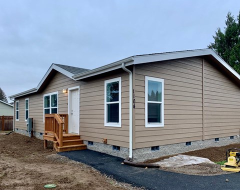 a home with siding on the side of a house