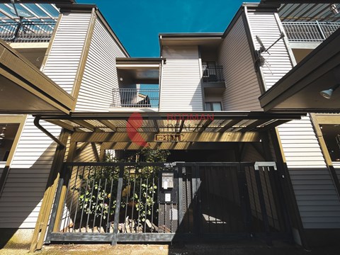 A building with a balcony and a black gate.