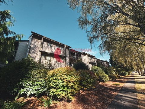 A building with the word "BROADMAN" painted on it is surrounded by greenery.