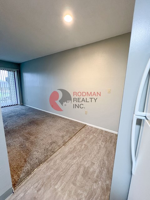 A room with Rodman Realty Inc. logo on the wall.