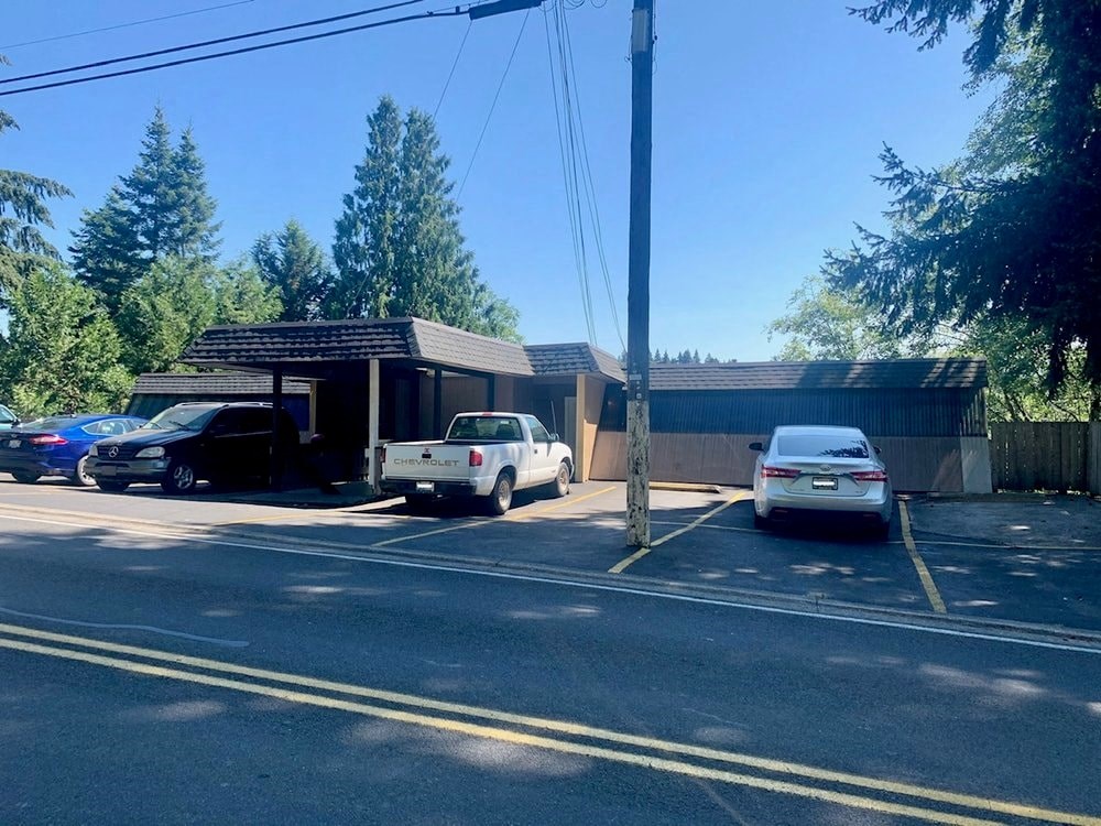 a parking lot with cars in front of a building