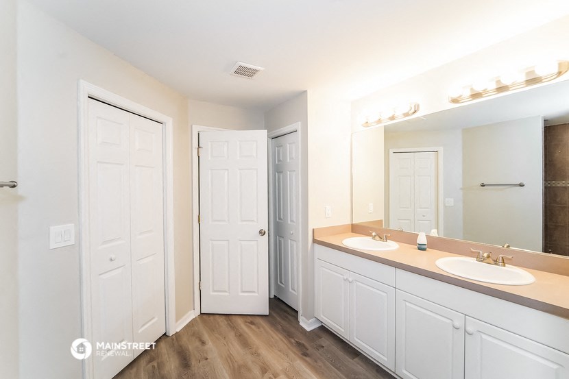 a bathroom with two sinks and a large mirror