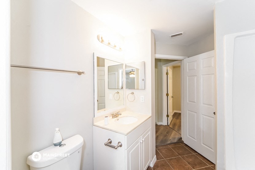 a bathroom with a sink and a mirror and a toilet