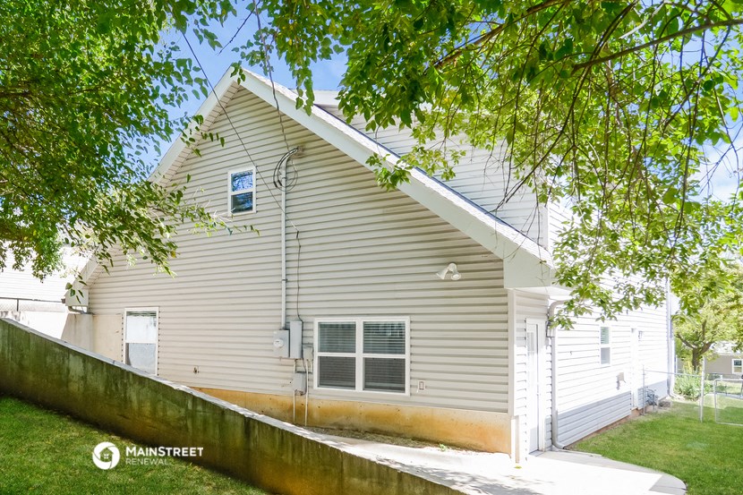 a white house with a tree in front of it