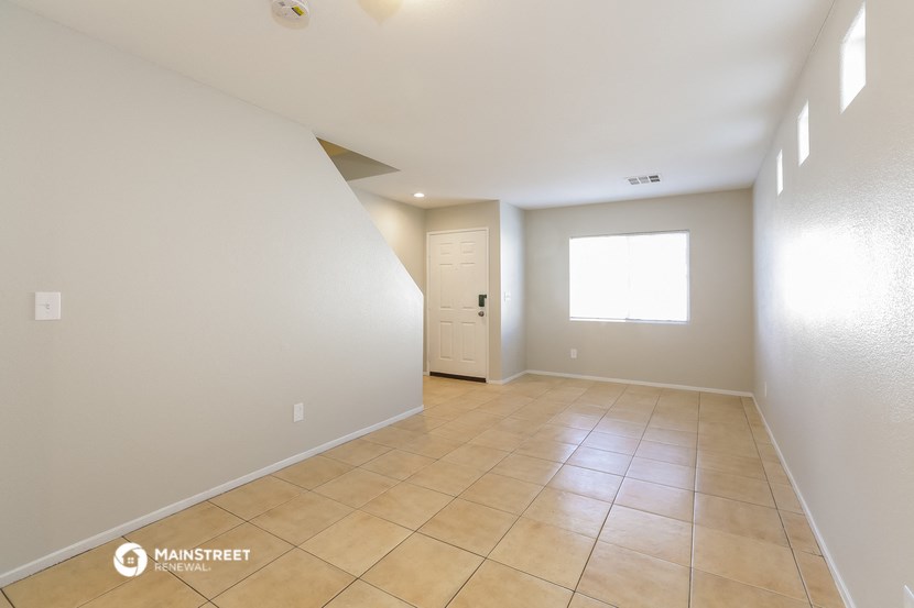 the living room and entryway of an empty house
