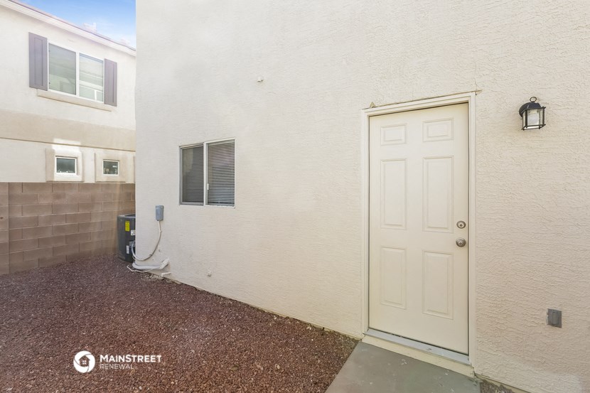 a garage door on the side of a white house