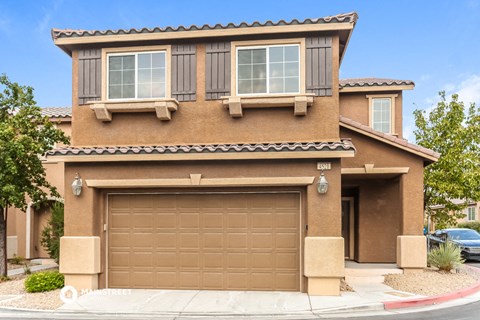a house with a garage door in front of it