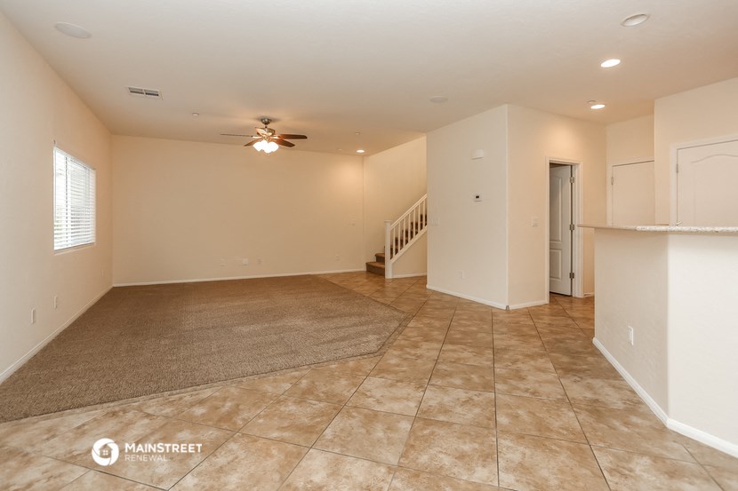 the living room and dining room of an empty house