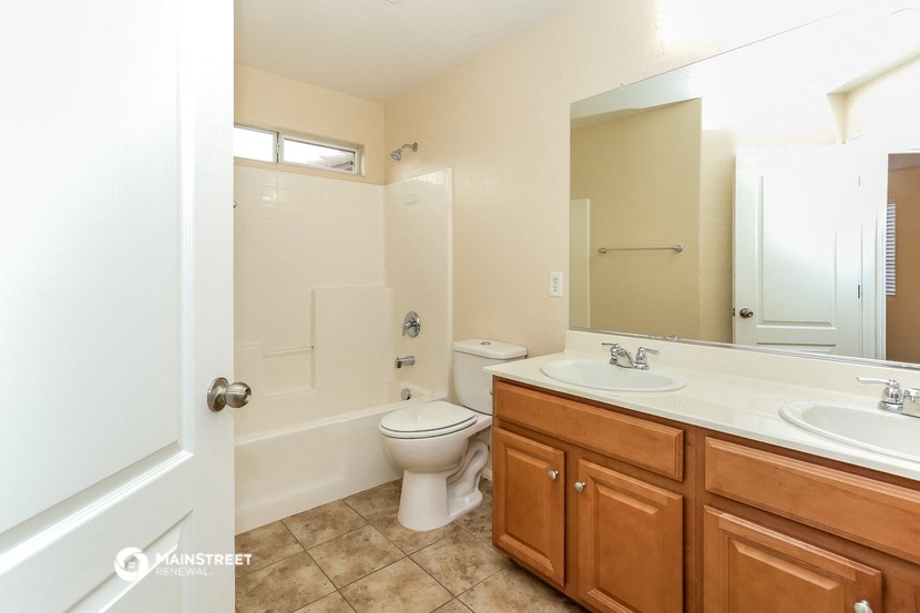 a bathroom with a toilet and a sink and a mirror