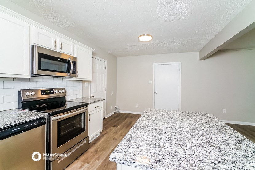 the kitchen of our studio apartment atrium with granite countertops and stainless steel appliances