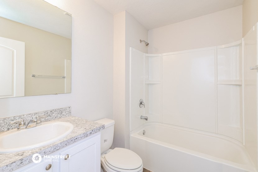 a bathroom with a sink toilet and shower and a bath tub